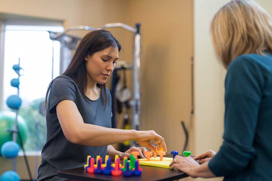 Occupational therapist works with a woman